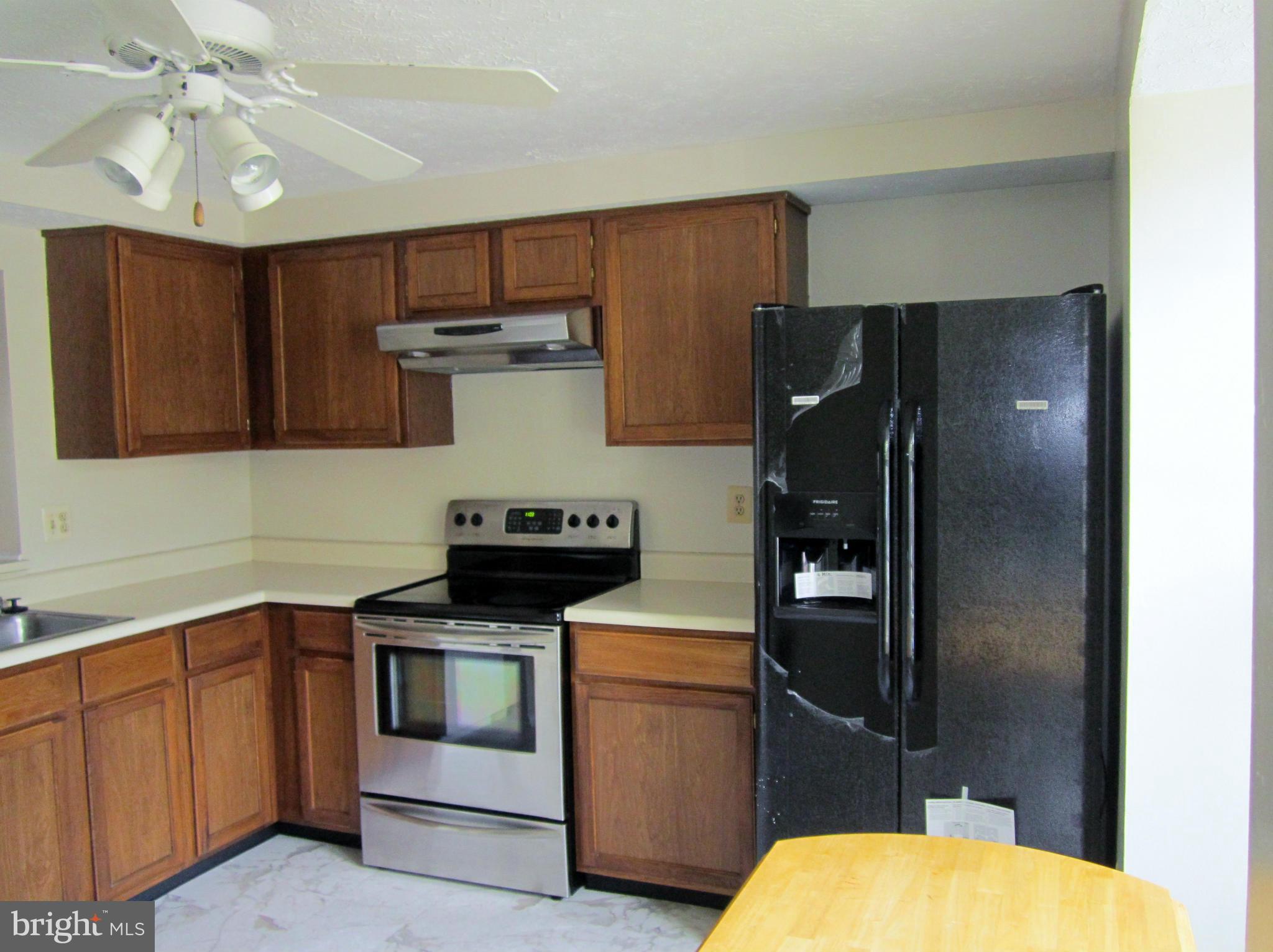 5021 Clifford Road Perry Hall, MD 21128 - Photo 4 of 15 a kitchen with a stove and a refrigerator