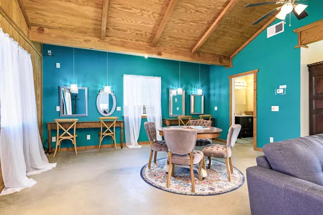 an aerial view of a house with a yard garden and patio