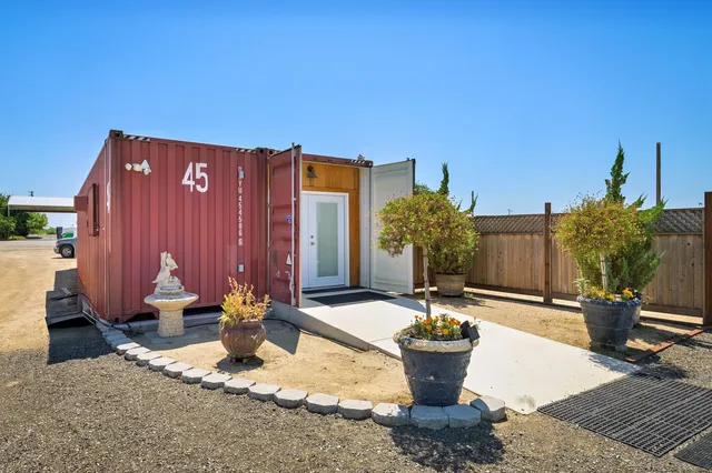 a view of a dining room with furniture and a chandelier
