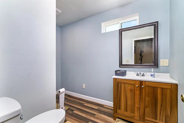 a bathroom with a sink a toilet and mirror