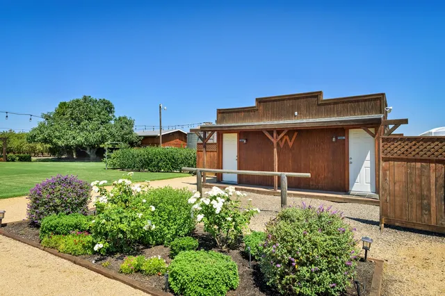 a bathroom with a granite countertop toilet a sink and a mirror