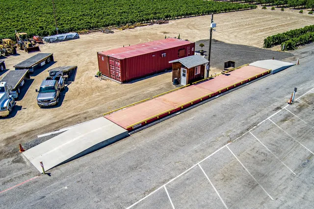 a backyard of a house with barbeque oven and outdoor seating