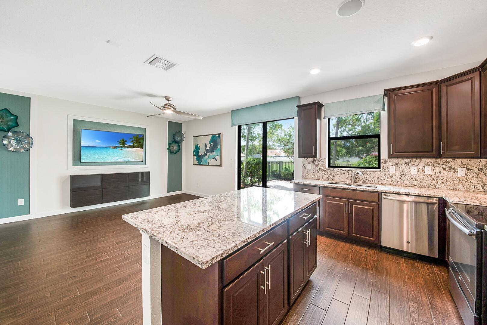 13076 Anthorne Lane Boynton Beach, FL 33436 - Photo 9 of 36 a kitchen with granite countertop cabinets a sink and appliances