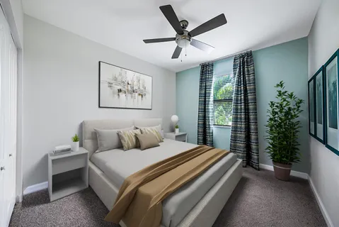 a bedroom with a large bed and a chandelier