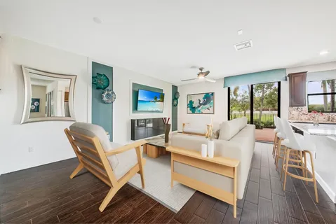 a living room with furniture and a wooden floor