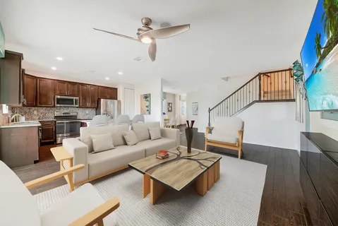 a living room with furniture a table and a large window