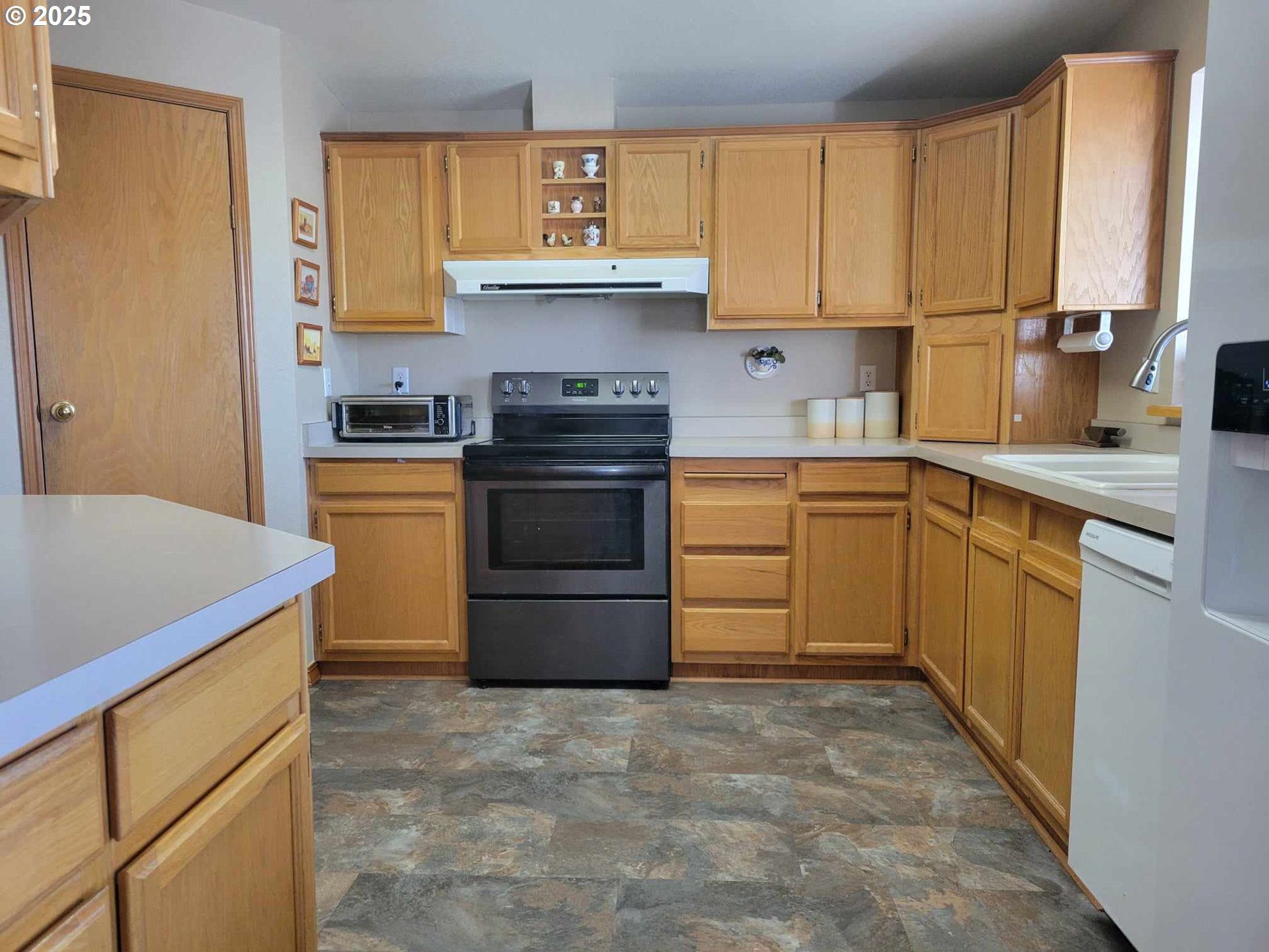 4413 Settlers Loop Forest Grove, OR 97116 - Photo 19 of 34 a kitchen with a stove sink and cabinets