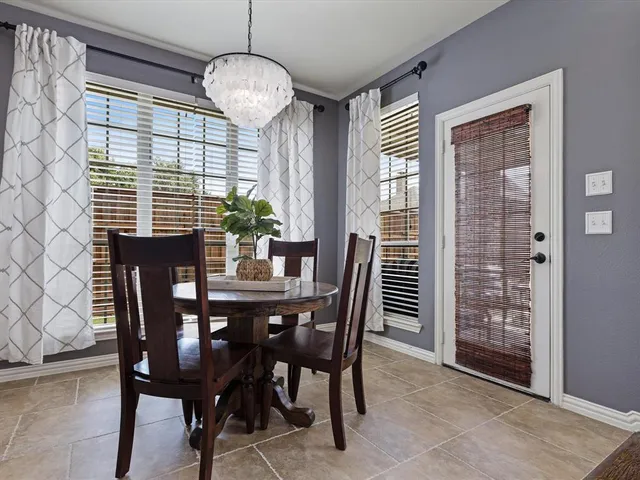 a living room with furniture kitchen view and a flat screen tv