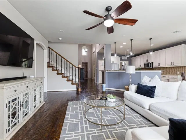 a view of a dining room with furniture a chandelier and wooden floor