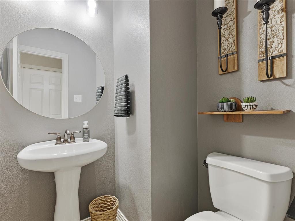 1120 Golden Sunset Court Prosper, TX 75078 - Photo 16 of 40 a bathroom with a toilet sink and mirror