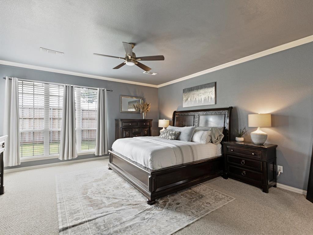 1120 Golden Sunset Court Prosper, TX 75078 - Photo 18 of 40 a spacious bedroom with a large bed and a large window