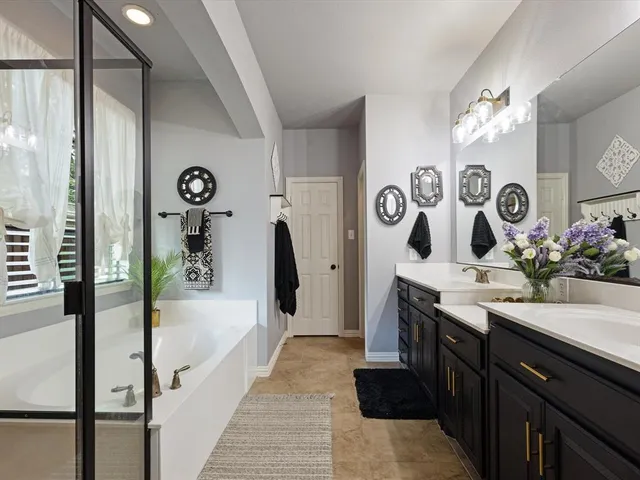 a kitchen with stainless steel appliances a white stove top oven and white cabinets