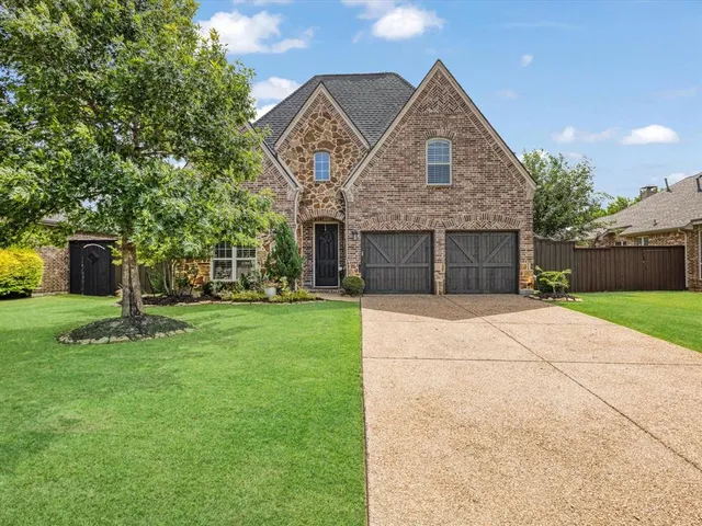 a front view of a house with a yard and a garage