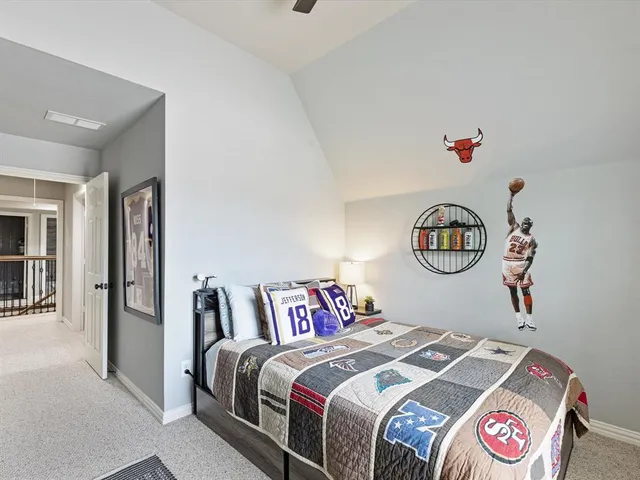 a bedroom with bed and a chandelier