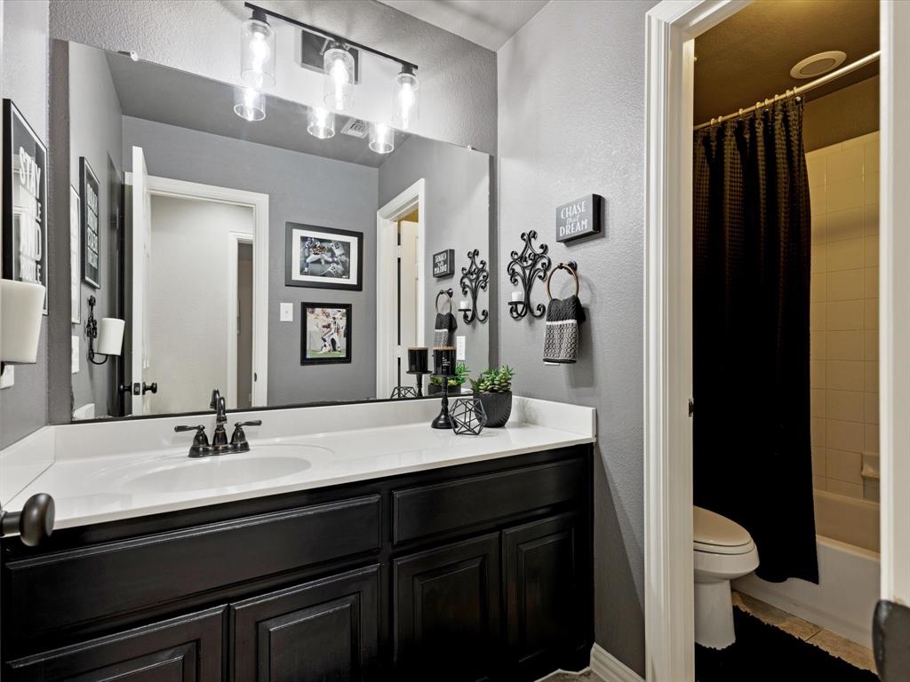 1120 Golden Sunset Court Prosper, TX 75078 - Photo 26 of 40 a bathroom with a double vanity sink toilet and shower
