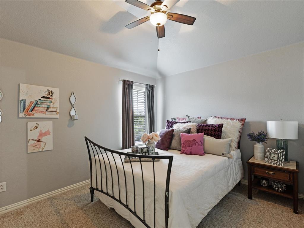 1120 Golden Sunset Court Prosper, TX 75078 - Photo 27 of 40 a bedroom with bed and a chandelier