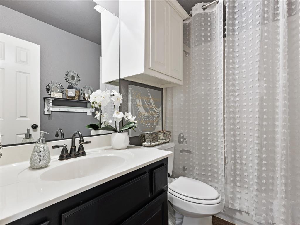 1120 Golden Sunset Court Prosper, TX 75078 - Photo 30 of 40 a bathroom with a sink a toilet and mirror