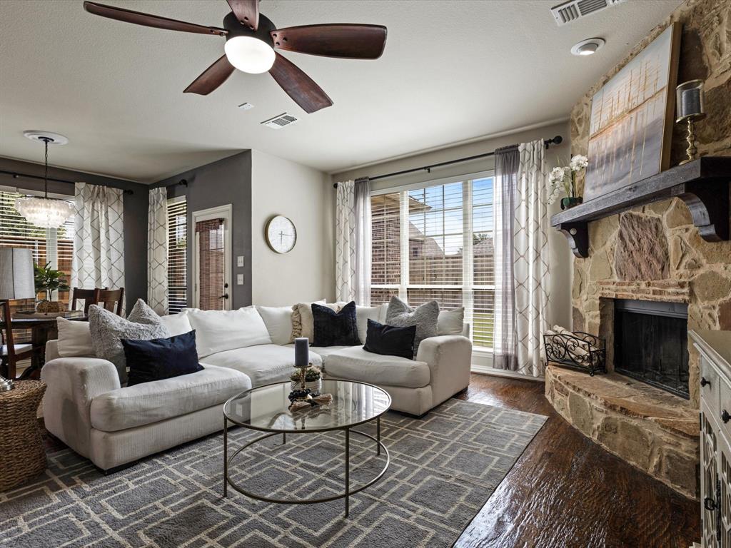 1120 Golden Sunset Court Prosper, TX 75078 - Photo 10 of 40 a living room with furniture a fireplace and a large window