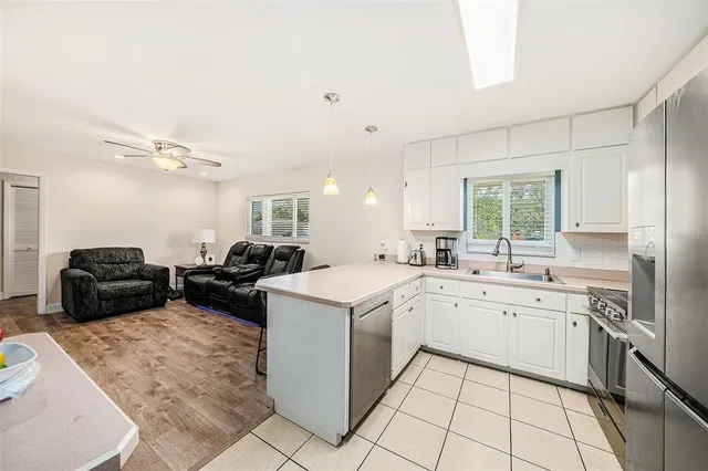 a kitchen with furniture a sink and a stove