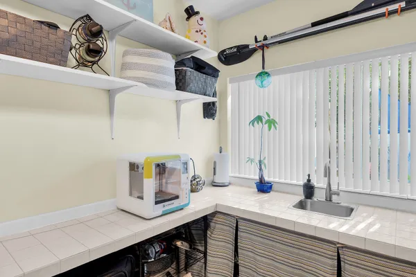 a kitchen with a sink a stove and cabinets