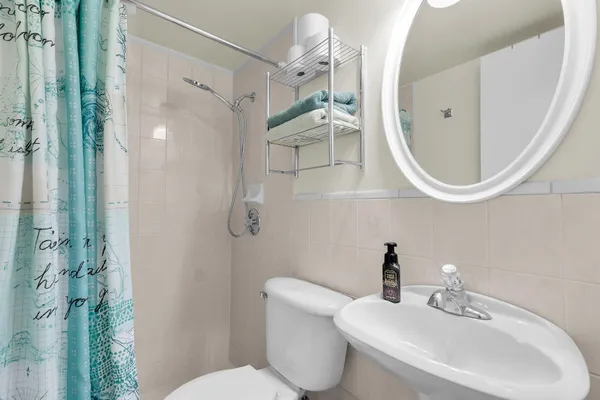 a bathroom with a toilet a sink and a mirror