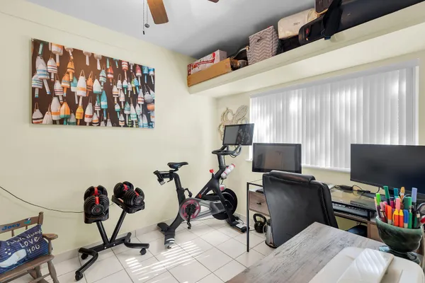 a bathroom with a granite countertop sink toilet a mirror a bathtub and shower