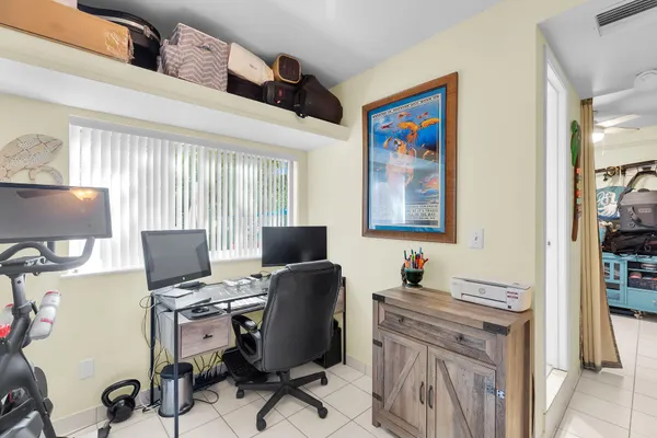 a bedroom with a bed and ceiling fan