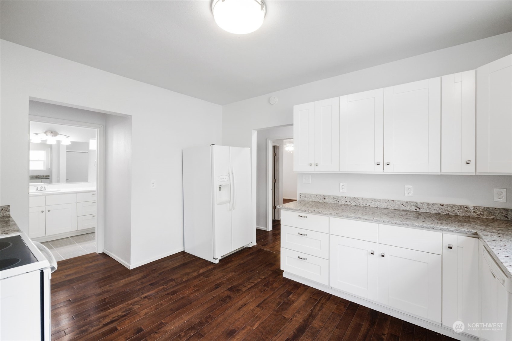 909 North 32nd Street Renton, WA 98056 - Photo 7 of 21 a kitchen with granite countertop white cabinets and white appliances