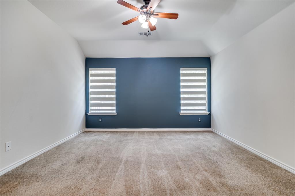 3504 Robin Road Ennis, TX 75119 - Photo 18 of 27 an empty room with windows and fan