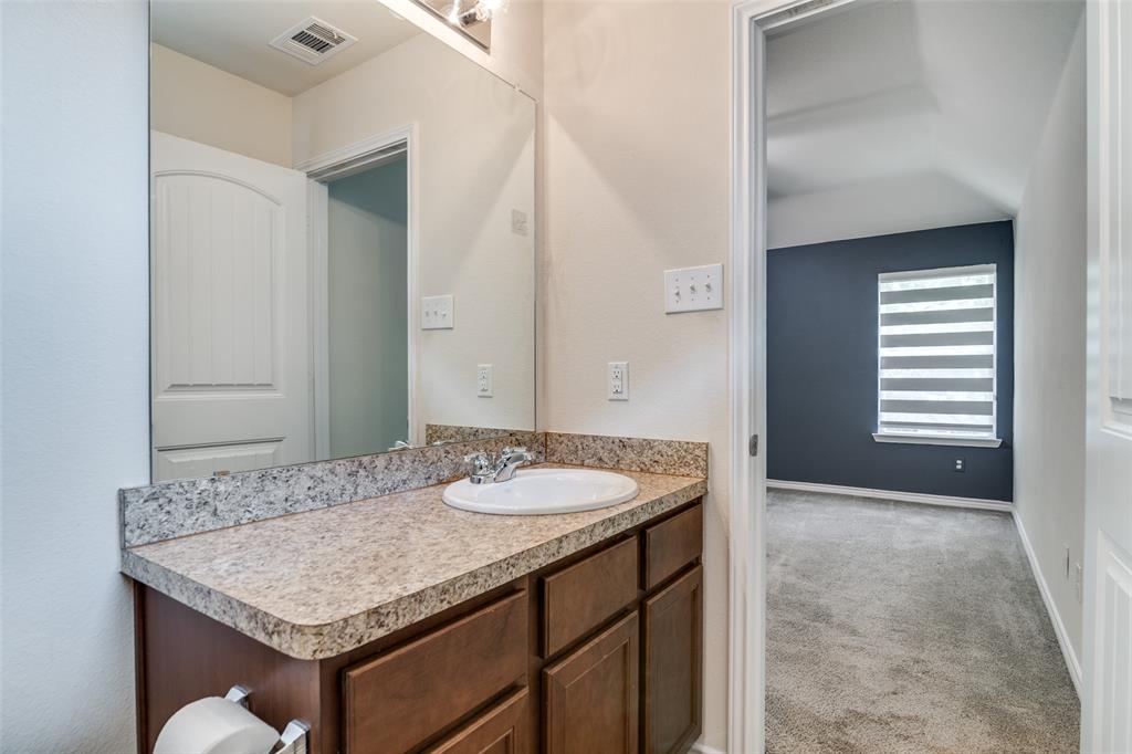 3504 Robin Road Ennis, TX 75119 - Photo 23 of 27 a bathroom with a granite countertop sink and a mirror