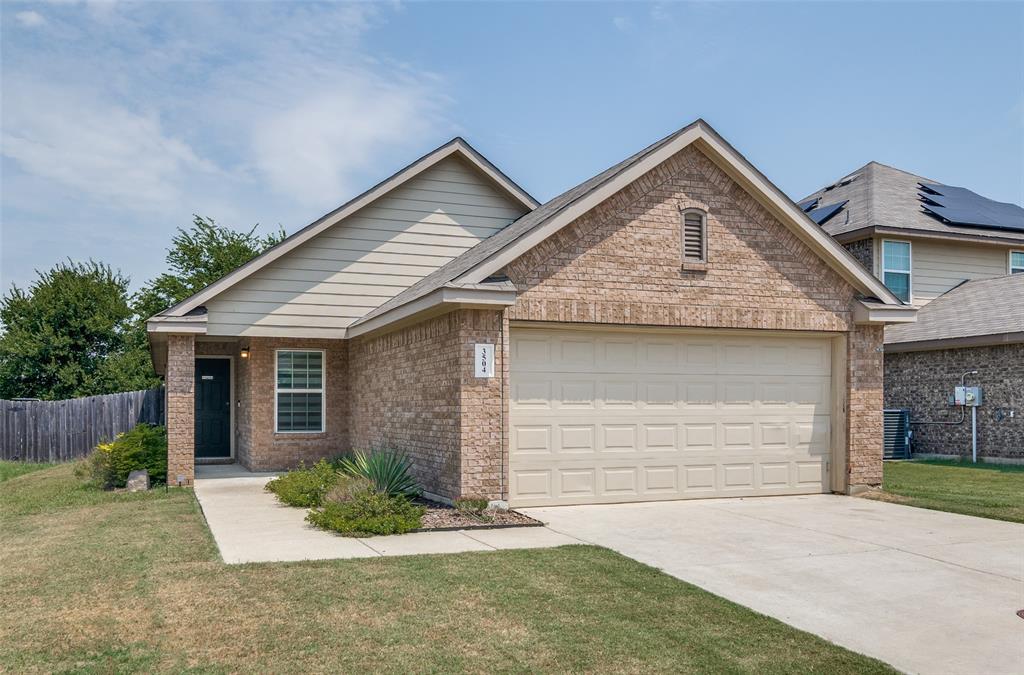 3504 Robin Road Ennis, TX 75119 - Photo 25 of 27 a front view of a house with a yard and garage