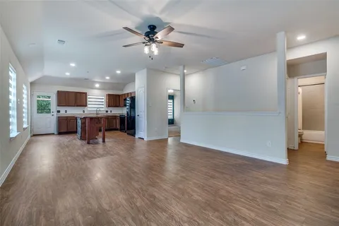 a view of a kitchen and a livingroom with furniture wooden floor kitchen view
