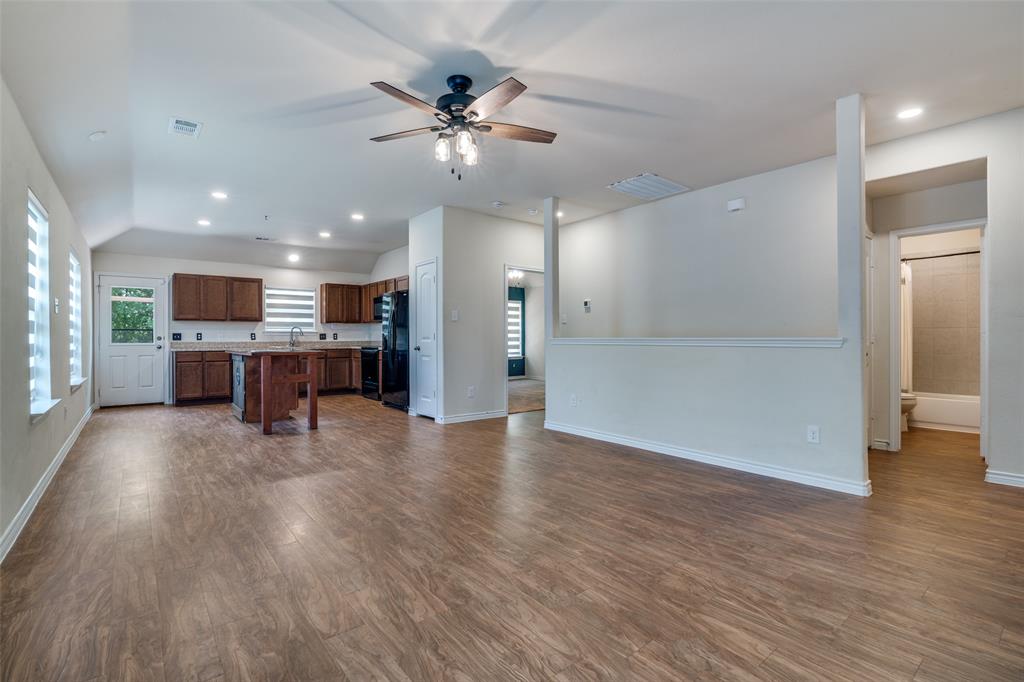 3504 Robin Road Ennis, TX 75119 - Photo 4 of 27 a view of a kitchen and a livingroom with furniture wooden floor kitchen view