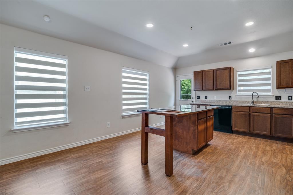 3504 Robin Road Ennis, TX 75119 - Photo 6 of 27 a kitchen with a sink cabinets and wooden floor
