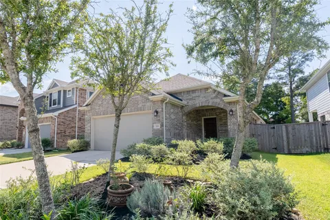 a front view of a house with a yard and fountain in middle