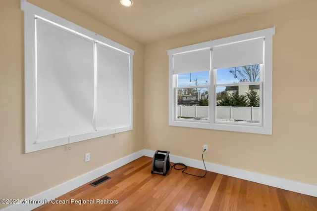 a view of a room with wooden floor and a window
