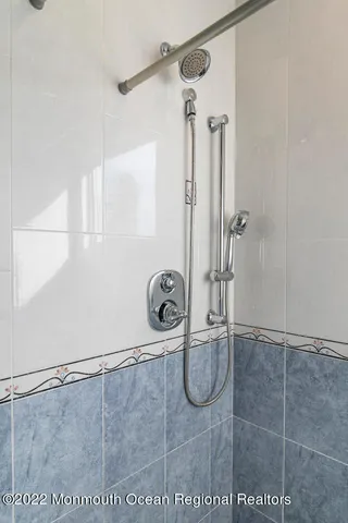 a bathroom with a sink a mirror and shower