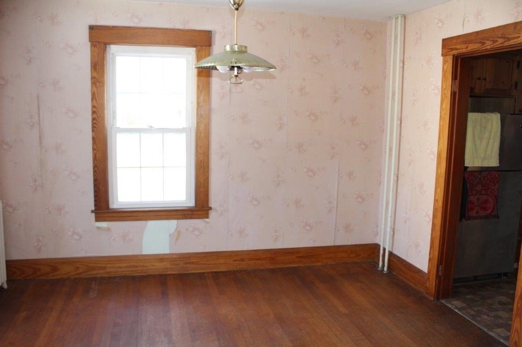 737 Worcester Road Barre, MA 01005 - Photo 8 of 19 a view of an empty room with wooden floor and a window