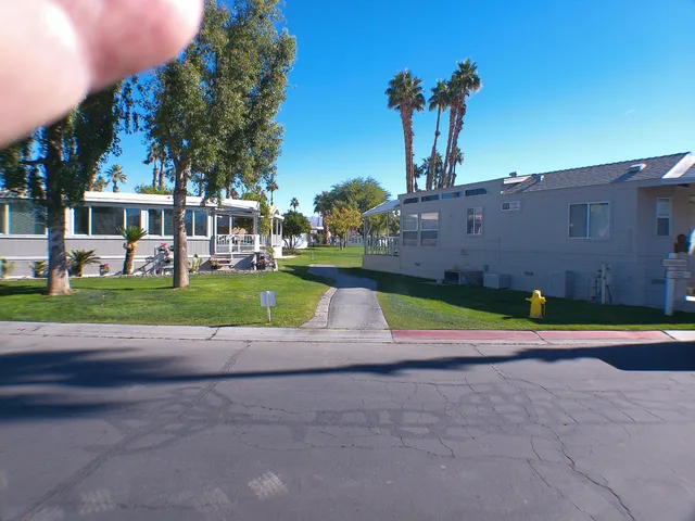 a view of yard with swimming pool and seating area