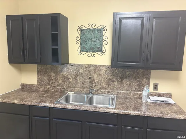 a stove top oven sitting inside of a kitchen