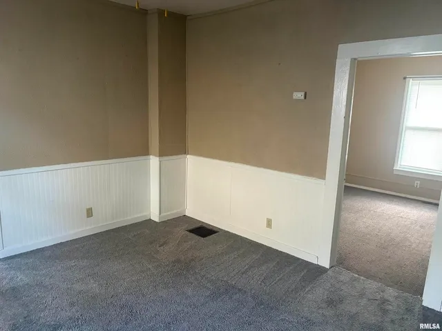 a view of a livingroom with wooden floor and a window