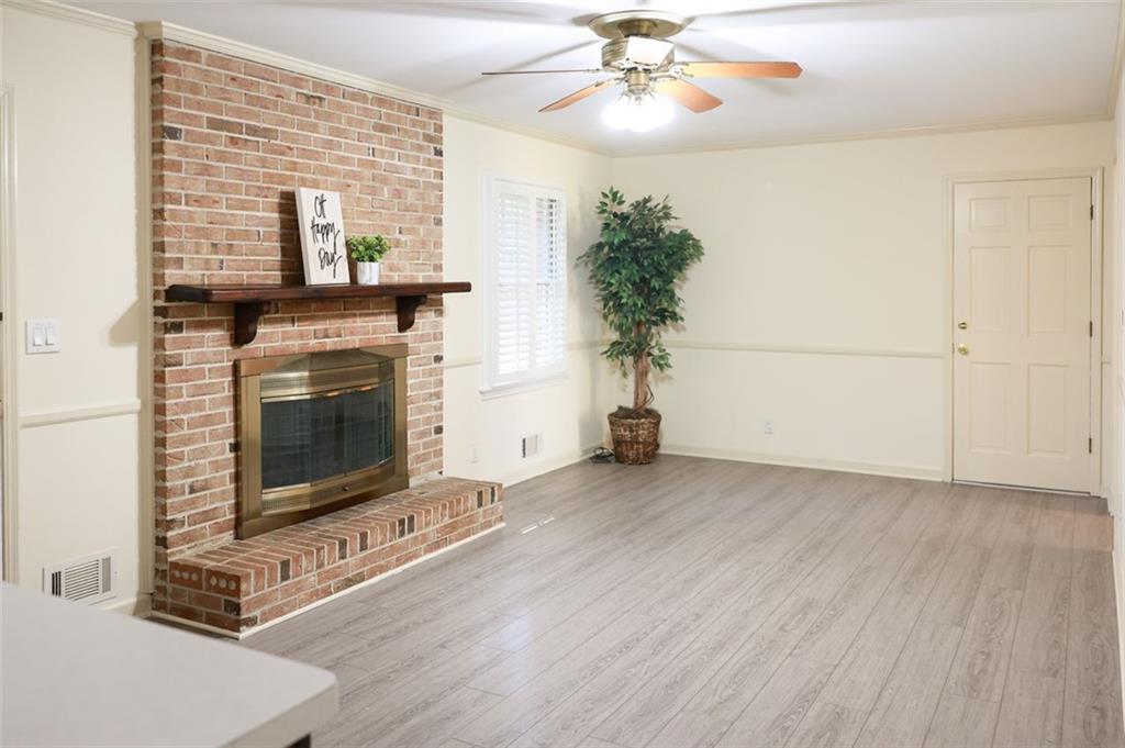 3969 Briaridge Circle Atlanta, GA 30340 - Photo 13 of 35 an empty room with a fireplace and chandelier fan