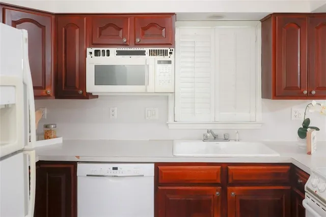 a kitchen with stainless steel appliances wooden cabinets and a sink