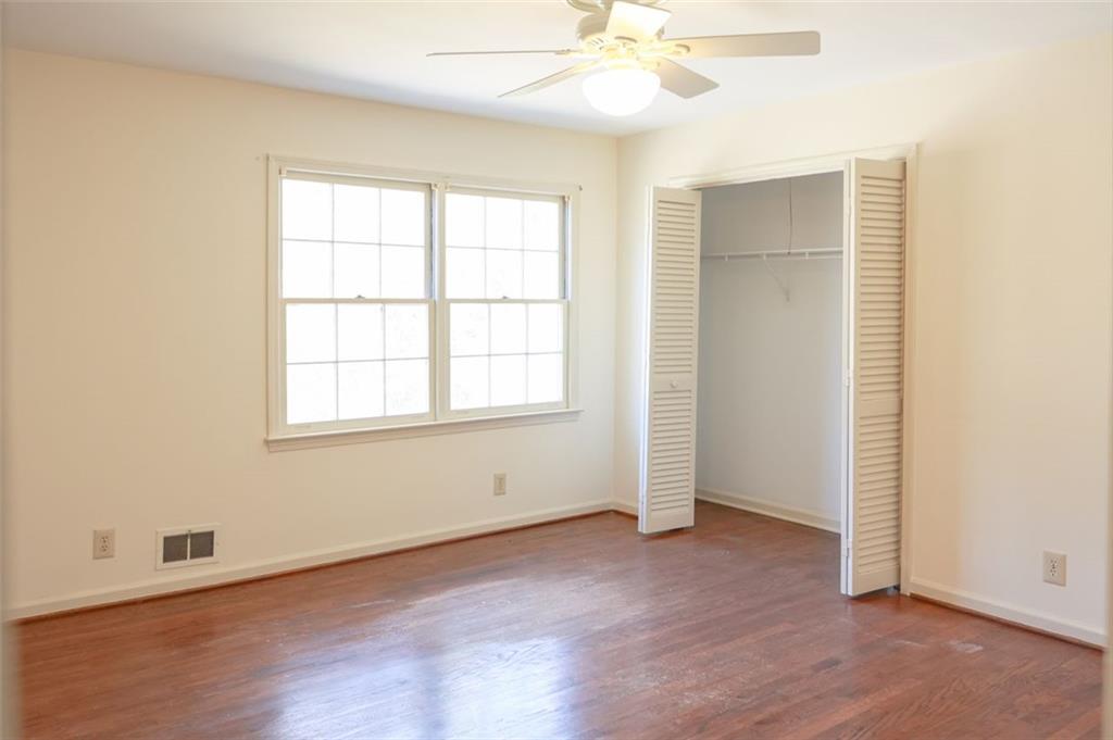 3969 Briaridge Circle Atlanta, GA 30340 - Photo 25 of 35 an empty room with wooden floor fan and windows