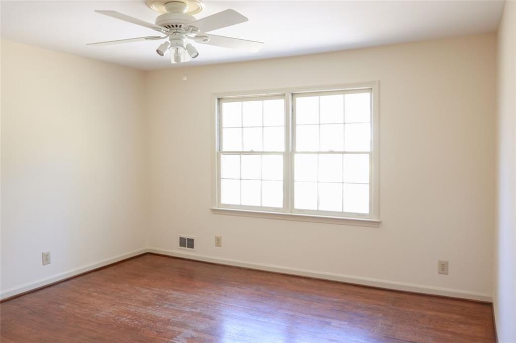 3969 Briaridge Circle Atlanta, GA 30340 - Photo 26 of 35 an empty room with wooden floor fan and windows