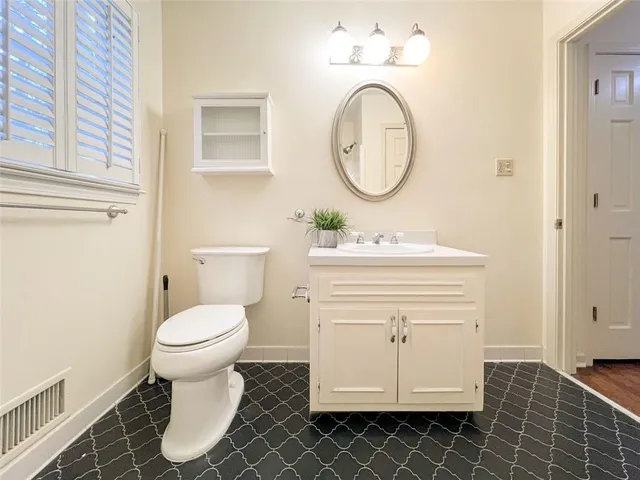 a bathroom with a sink toilet and a mirror