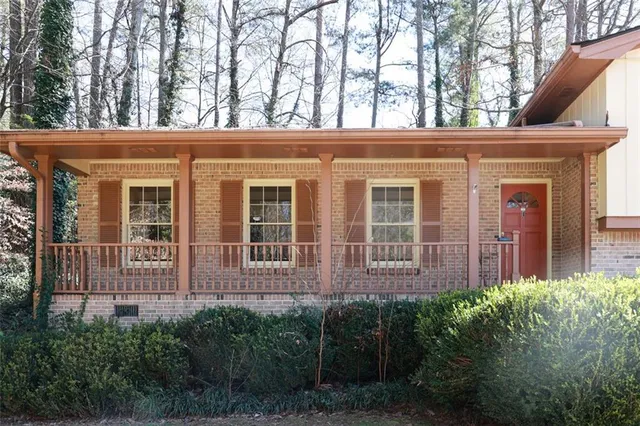 a view of a house with large windows and a yard