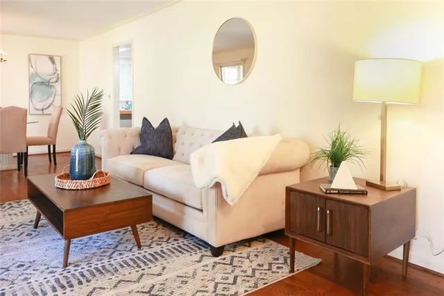 a living room with furniture and a lamp