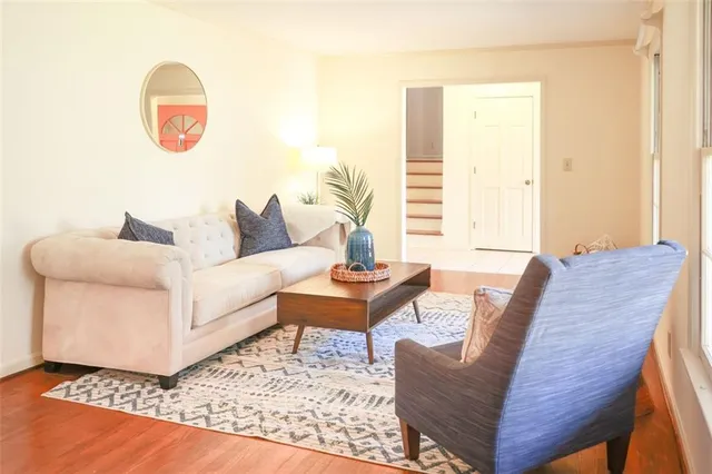 a living room with furniture and a wooden floor