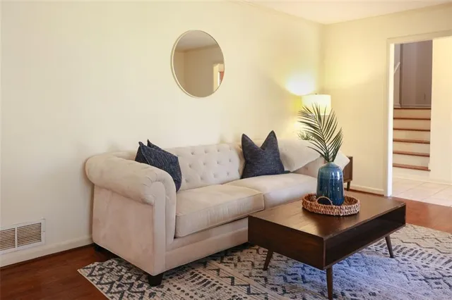 a living room with furniture and a potted plant
